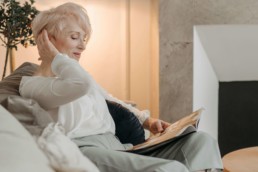 mujer leyendo y relajada con audífonos
